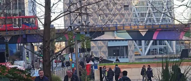 Dynamic view of people and buses at Canary Wharf, London.