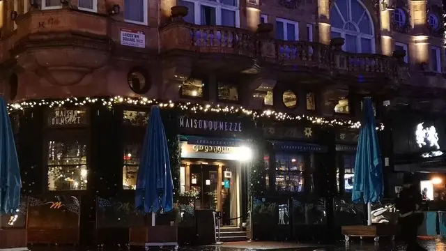Explore London at night with festive lights and bustling streets.