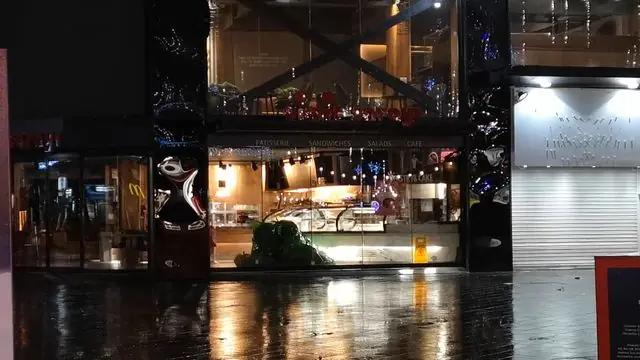 City center restaurant with Christmas decorations at night.