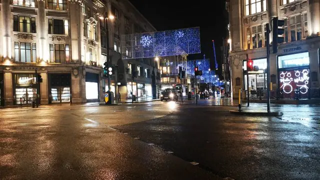 Christmas lights illuminating Regent Street, London at night.