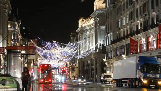 Christmas lights on Regent Street, London during a rainy night.