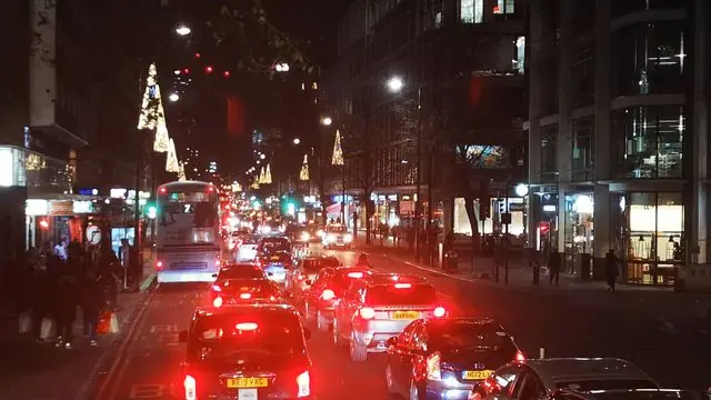 Experience the night life of London city during Christmas with lively traffic and festive lights.