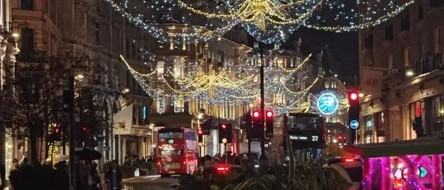 Regent Street dazzles with Christmas lights and festive bustle at night.