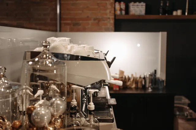 A cozy coffee shop interior with an espresso machine and seating